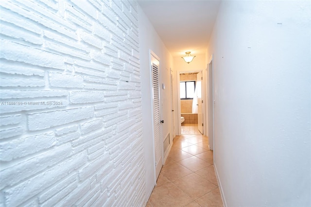 corridor with light tile patterned floors