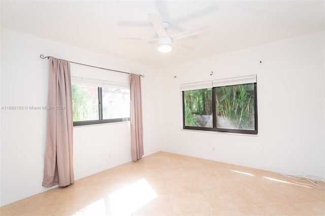 empty room featuring ceiling fan and light tile patterned flooring