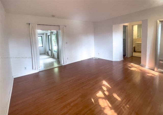 empty room featuring dark wood-type flooring