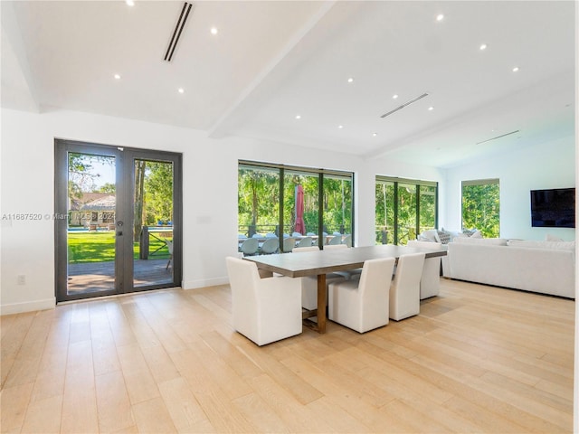 unfurnished dining area with lofted ceiling with beams, light wood-type flooring, and french doors