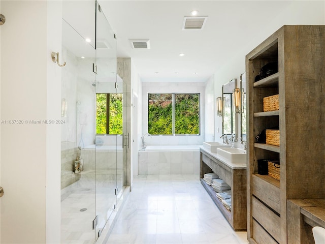 bathroom with independent shower and bath and vanity