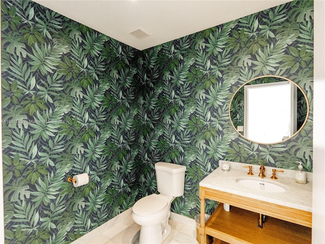 bathroom with vanity, tile patterned floors, and toilet