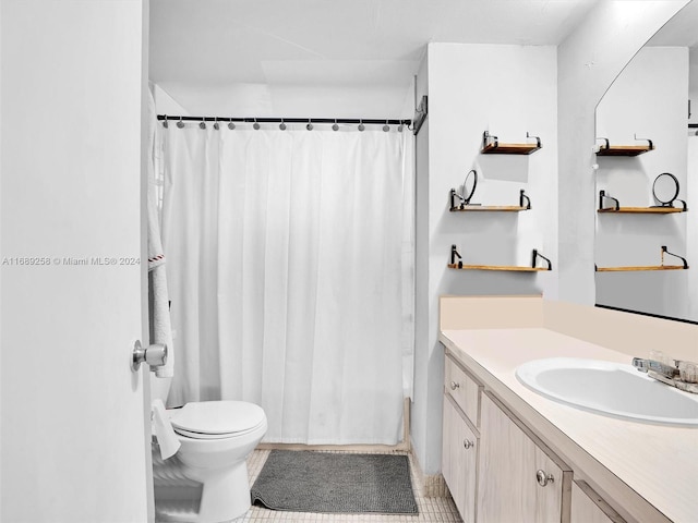 bathroom with vanity, a shower with shower curtain, tile patterned floors, and toilet