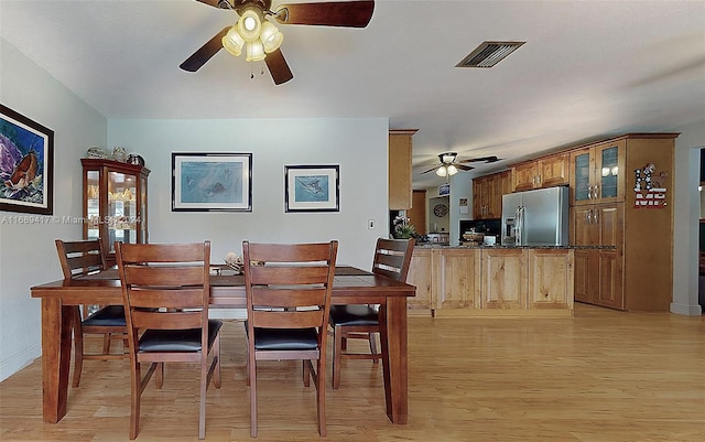 dining room with ceiling fan and light hardwood / wood-style flooring