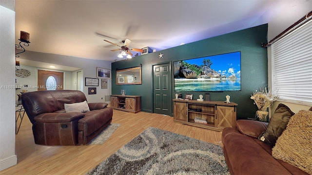 living room featuring hardwood / wood-style floors and ceiling fan