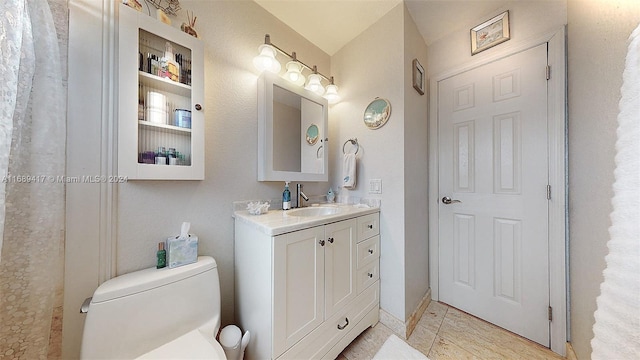 bathroom with toilet and vanity