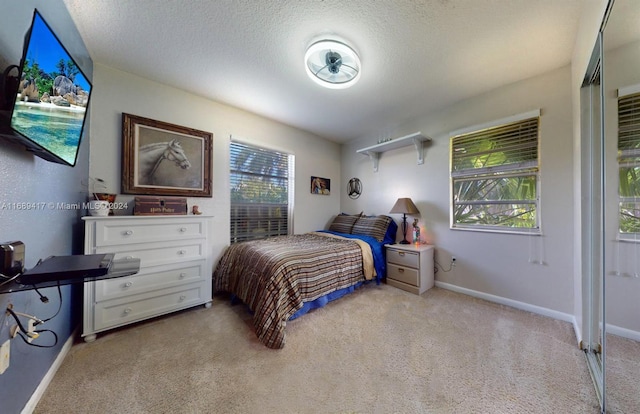 carpeted bedroom with a textured ceiling