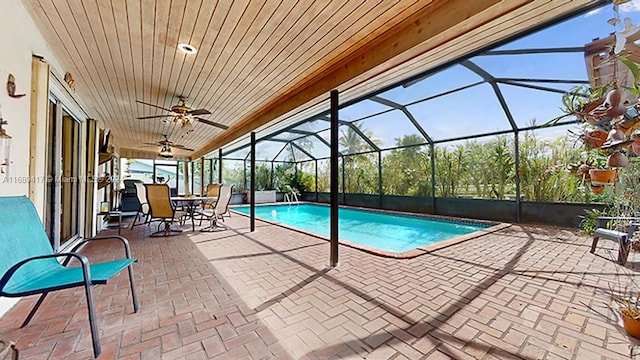 view of pool featuring a patio area, a lanai, and ceiling fan