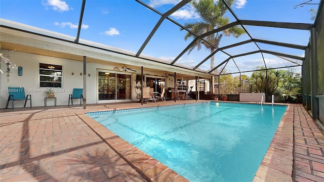 view of swimming pool featuring a lanai, ceiling fan, and a patio