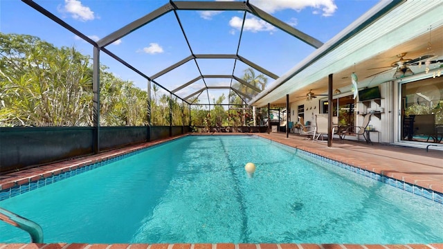 view of pool featuring ceiling fan, a patio, and a lanai