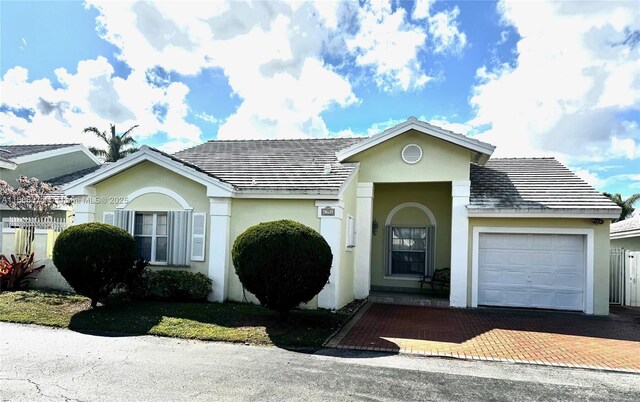 ranch-style home with a front lawn and a garage