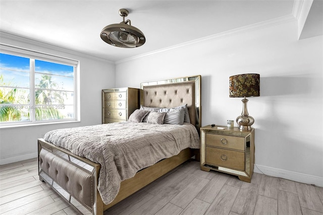 bedroom with ornamental molding and light hardwood / wood-style floors