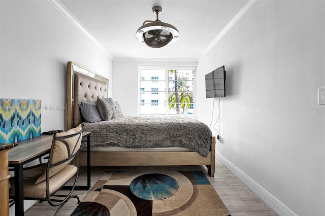 bedroom featuring crown molding and light hardwood / wood-style flooring