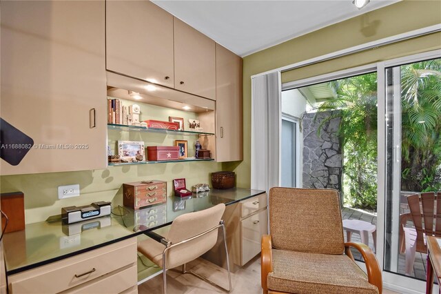 office space featuring built in desk and light hardwood / wood-style floors