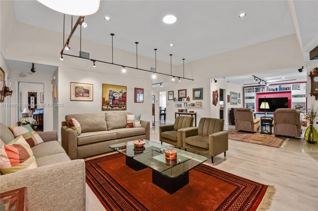 living room with ceiling fan and light hardwood / wood-style flooring