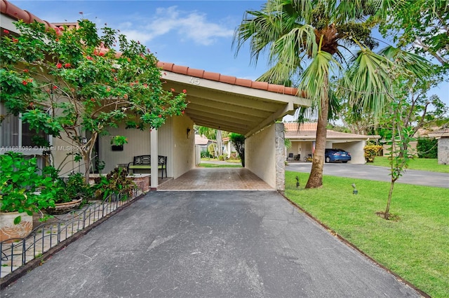 view of car parking featuring a yard and a carport