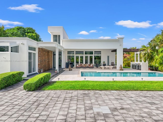 rear view of property featuring a patio