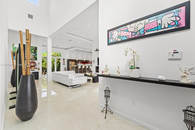 interior space featuring a towering ceiling and plenty of natural light