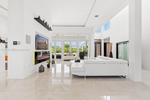 living room featuring a high ceiling and french doors