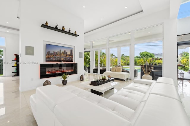 living room featuring french doors and a high ceiling