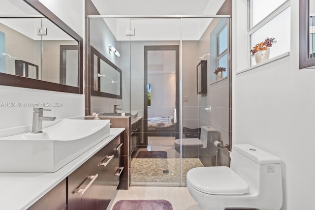 bathroom featuring tile patterned floors, vanity, toilet, and an enclosed shower