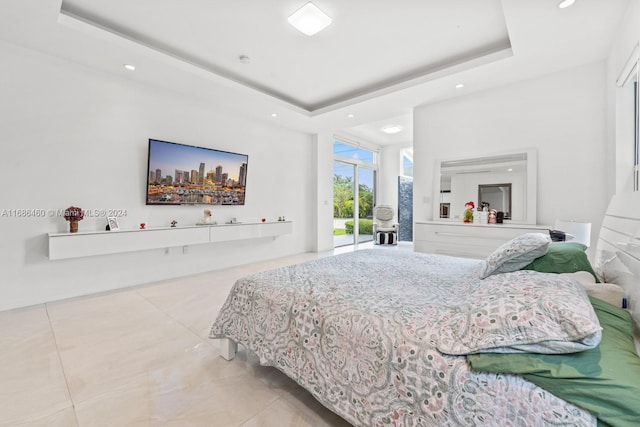 tiled bedroom with a raised ceiling