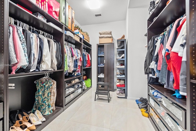 walk in closet with tile patterned flooring