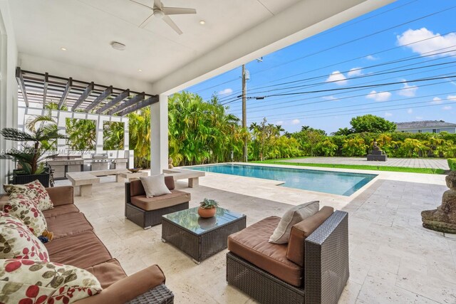 view of pool with an outdoor living space, ceiling fan, a patio, an outdoor kitchen, and a pergola