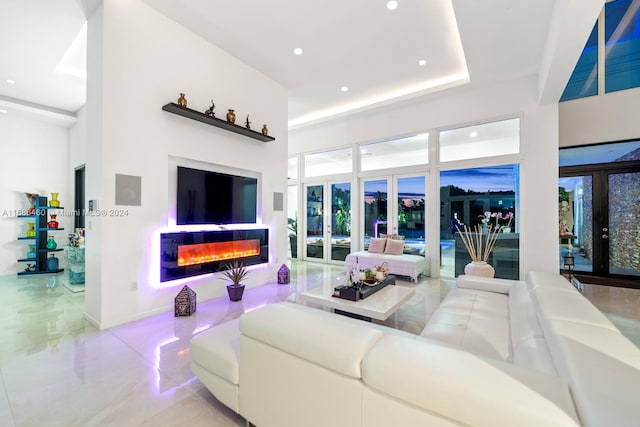 living room featuring french doors and a high ceiling