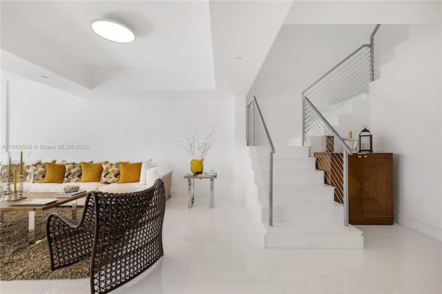 interior space with tile patterned floors and a tray ceiling