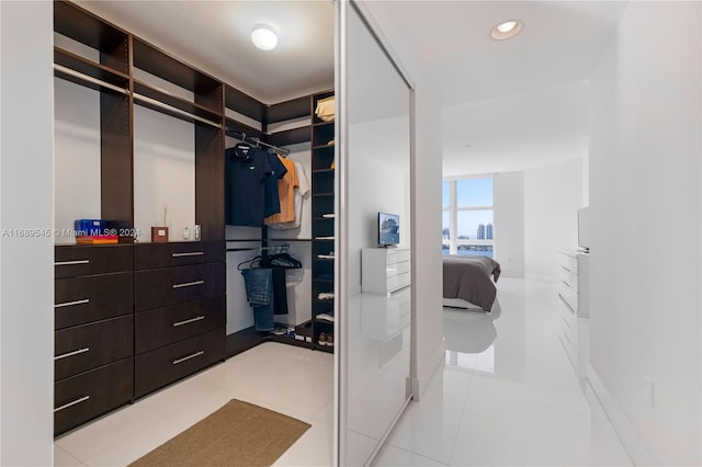 walk in closet featuring light tile patterned flooring