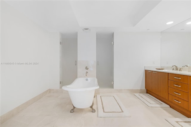 bathroom featuring vanity and shower with separate bathtub