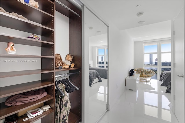 walk in closet featuring light tile patterned flooring