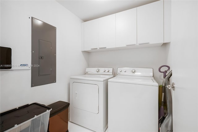 laundry area featuring electric panel, cabinets, and independent washer and dryer