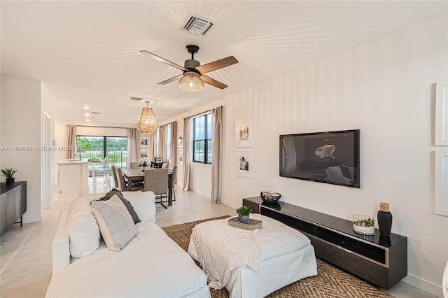 living room featuring light tile patterned floors and ceiling fan