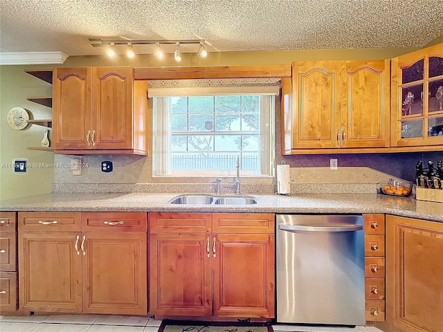 kitchen featuring dishwasher, a textured ceiling, sink, ornamental molding, and light tile patterned flooring