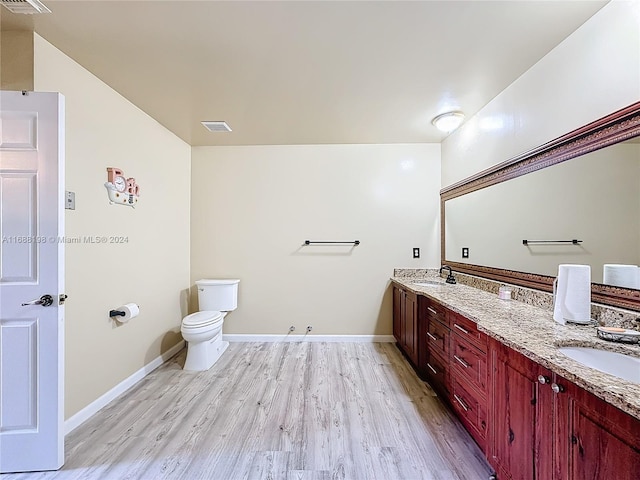 bathroom featuring hardwood / wood-style flooring, vanity, and toilet