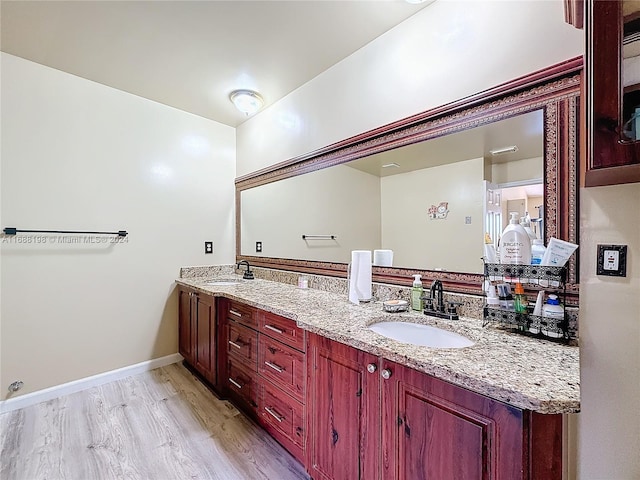 bathroom featuring hardwood / wood-style flooring and vanity