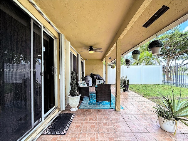 view of patio featuring ceiling fan