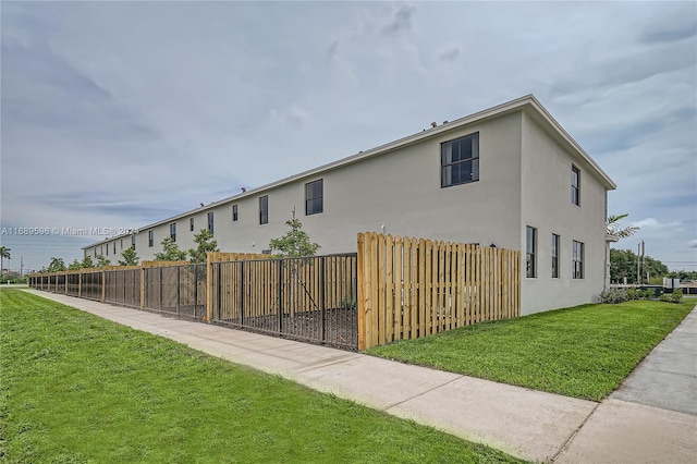 view of side of home with a yard