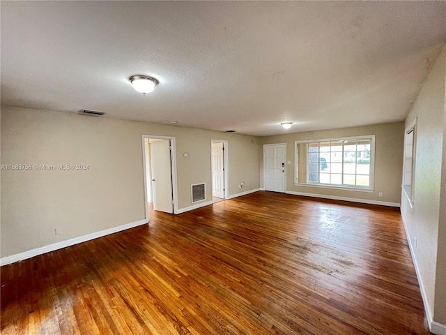 empty room featuring hardwood / wood-style floors and a textured ceiling