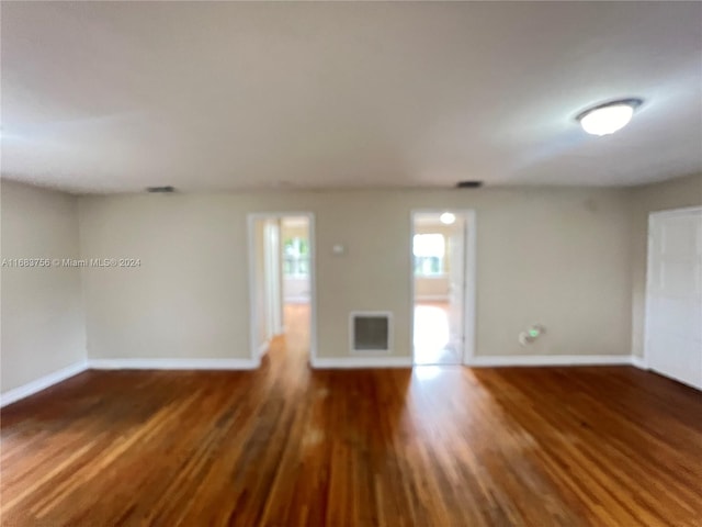 spare room featuring dark wood-type flooring