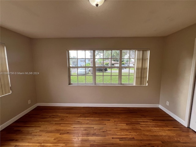 unfurnished room with wood-type flooring