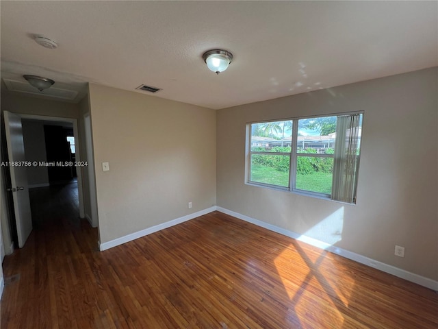 spare room featuring dark wood-type flooring