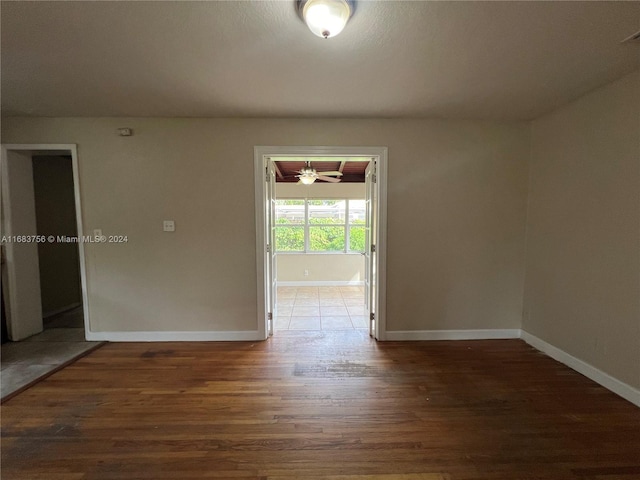 empty room featuring ceiling fan and dark hardwood / wood-style floors