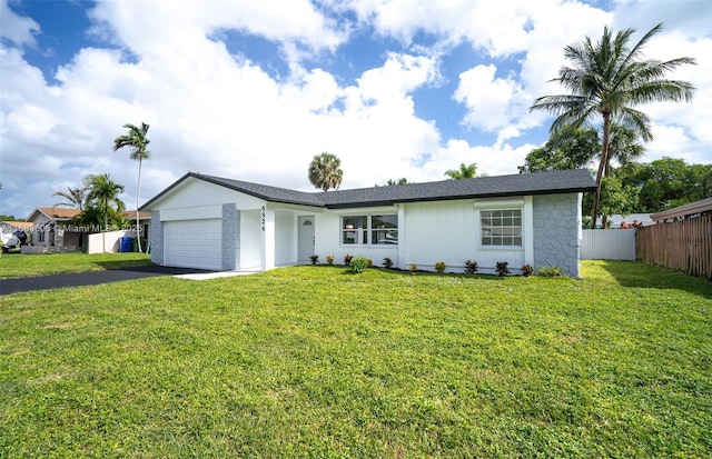 single story home with a front yard and a garage