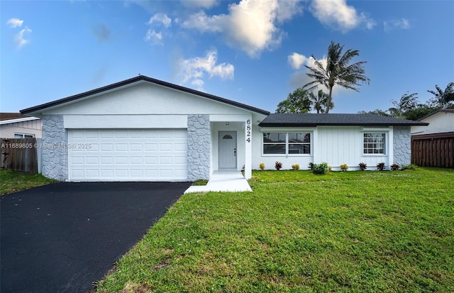 ranch-style house featuring a front yard and a garage