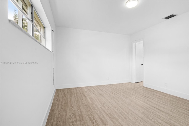 empty room with light hardwood / wood-style flooring