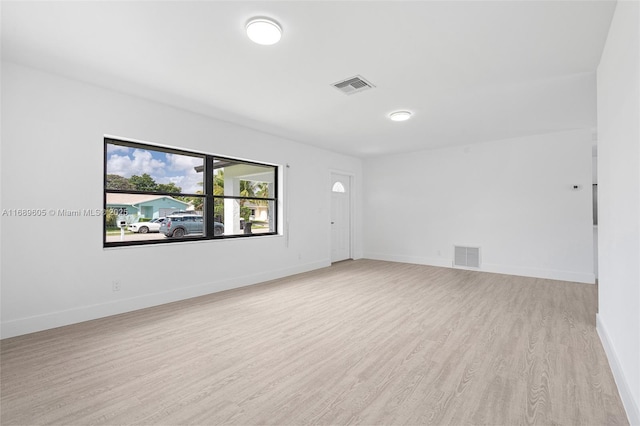 spare room featuring light wood-type flooring