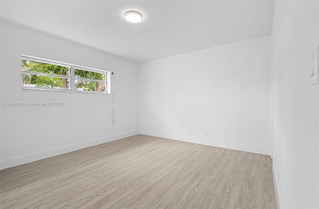 spare room featuring light hardwood / wood-style flooring